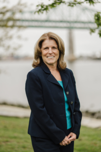 Smiling woman with brown hair in business suit.